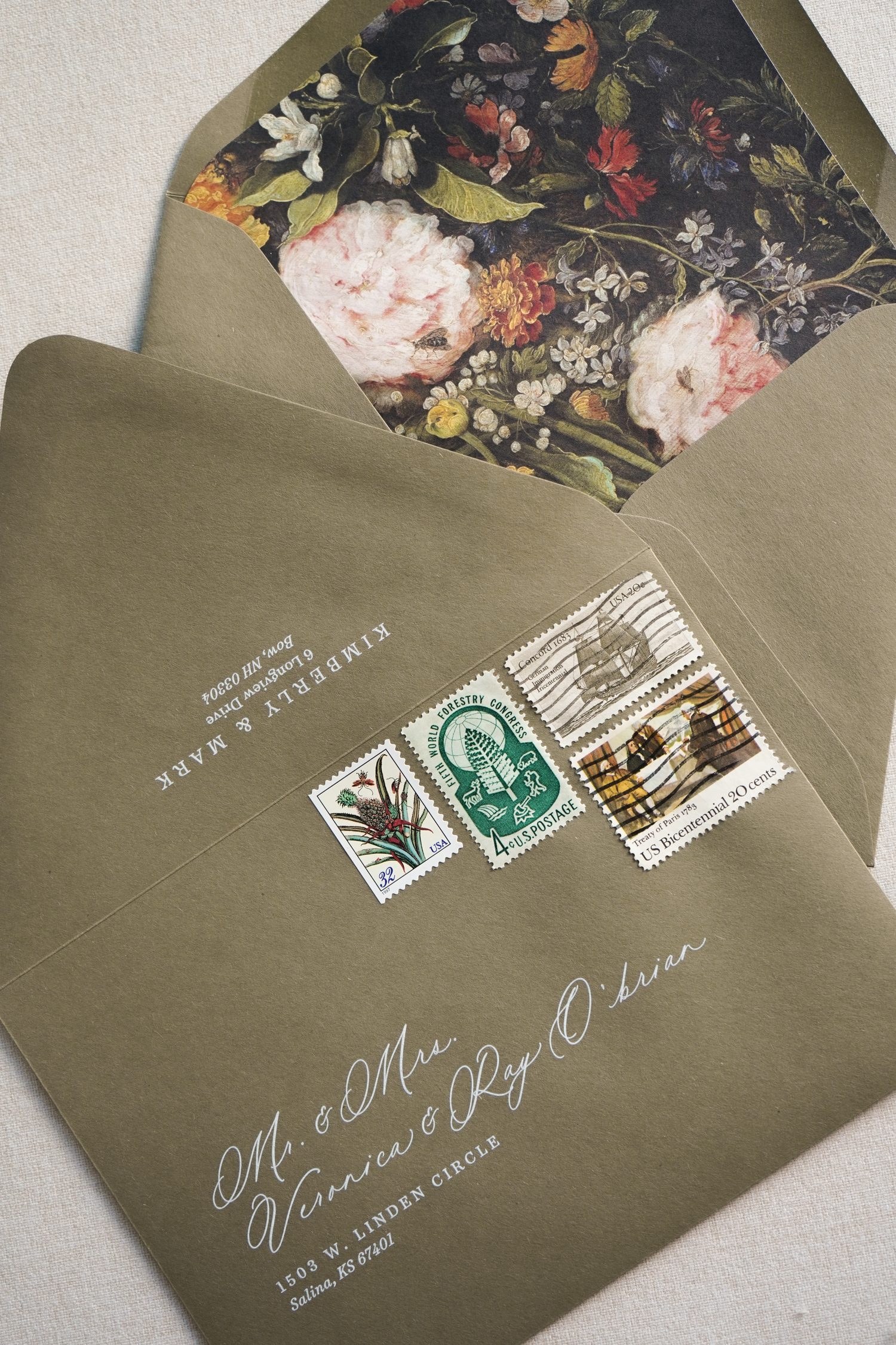 wedding invitation envelopes with liners, vintage stamps, and addresses