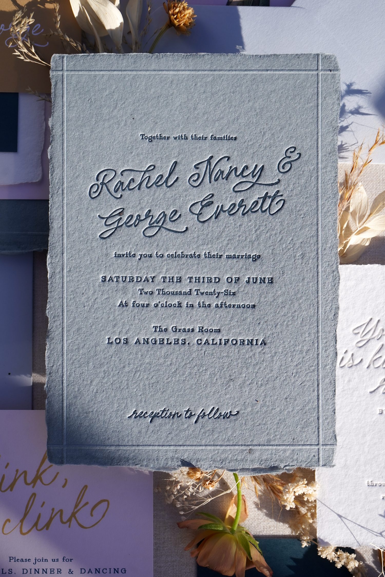 letterpress wedding invitations with blind emboss border on denim handmade paper